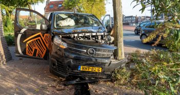 Busje total loss na botsing tegen paaltjes en boom bij gemeentehuis in Alblasserdam